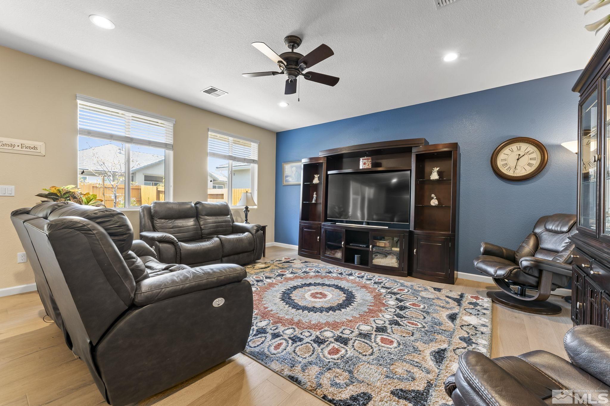 9593 Gazala Lane Reno, NV 89521 - Photo 4 of 37 a living room with furniture a clock tv and a window