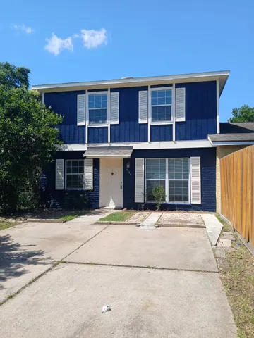 a front view of a house with a yard and a garage