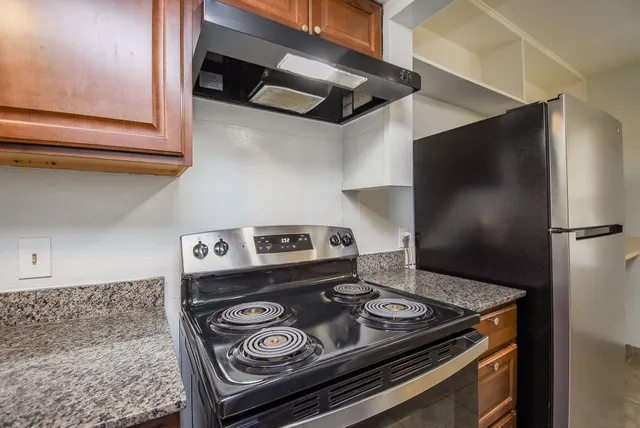 a stove top oven sitting inside of a kitchen