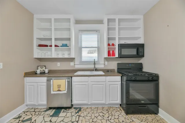 a kitchen with a sink stove and cabinets