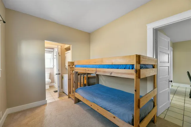 a bedroom with a bunk bed and a dresser