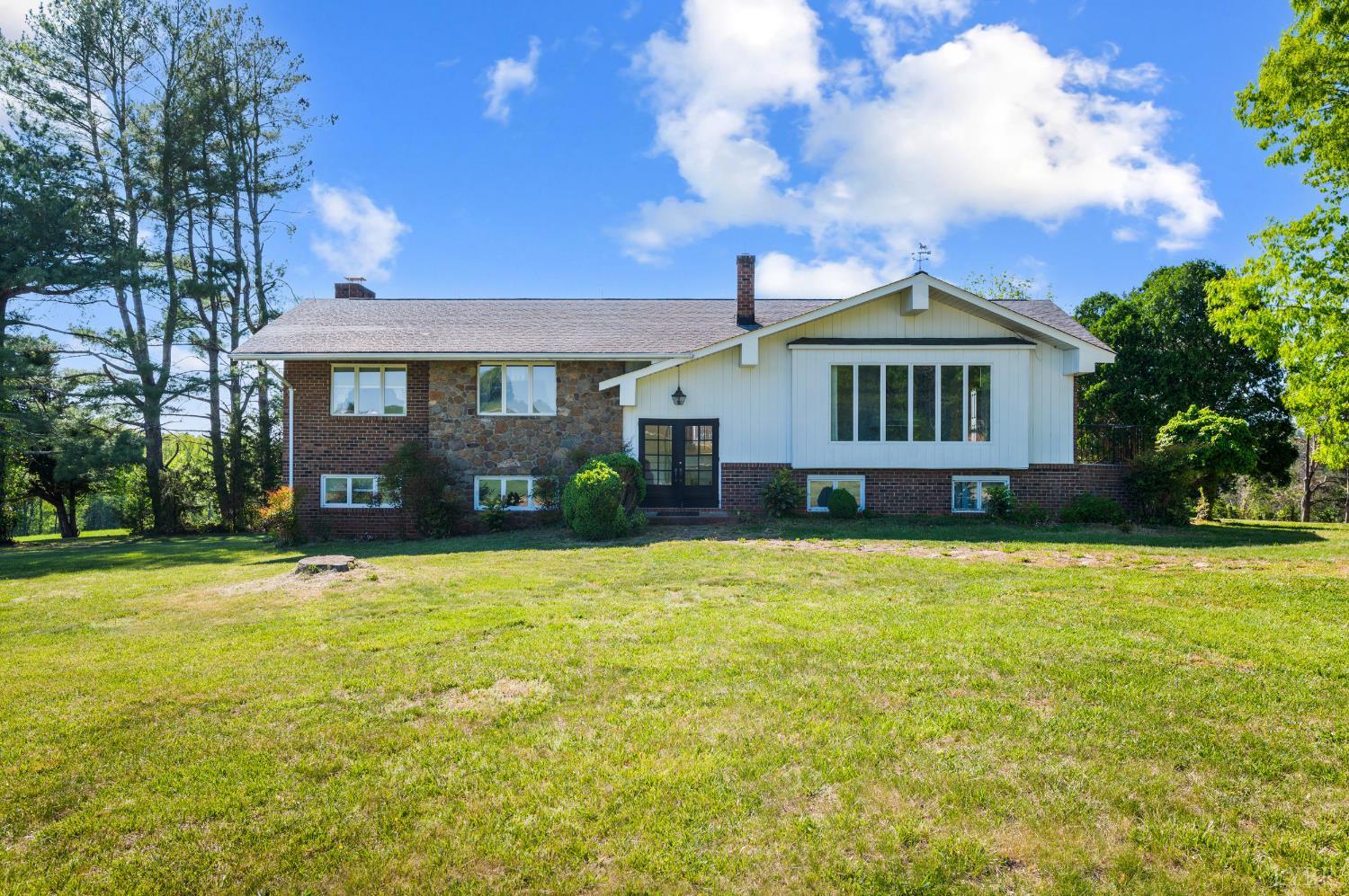 a front view of a house with yard and green space