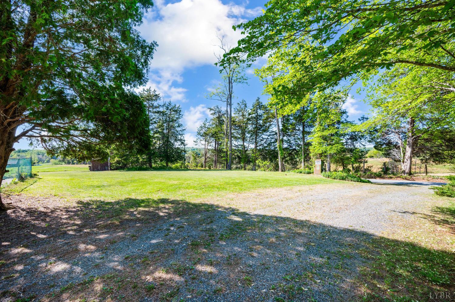 1250 Lick Run Farm Road Forest, VA 24551 - Photo 54 of 74 a view of a swimming pool with a yard and large trees