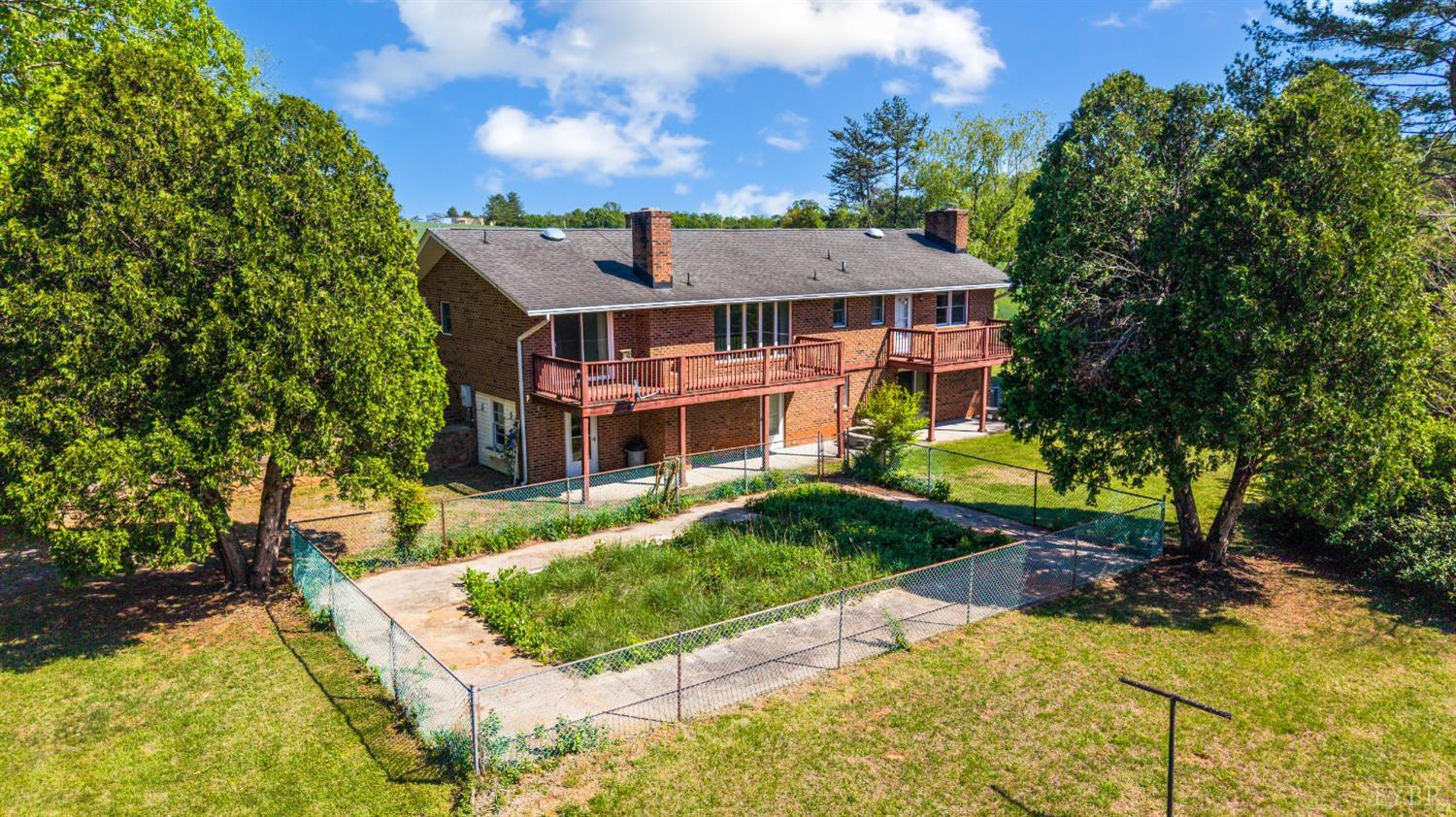 1250 Lick Run Farm Road Forest, VA 24551 - Photo 68 of 74 a view of a big house with a big yard plants and large trees