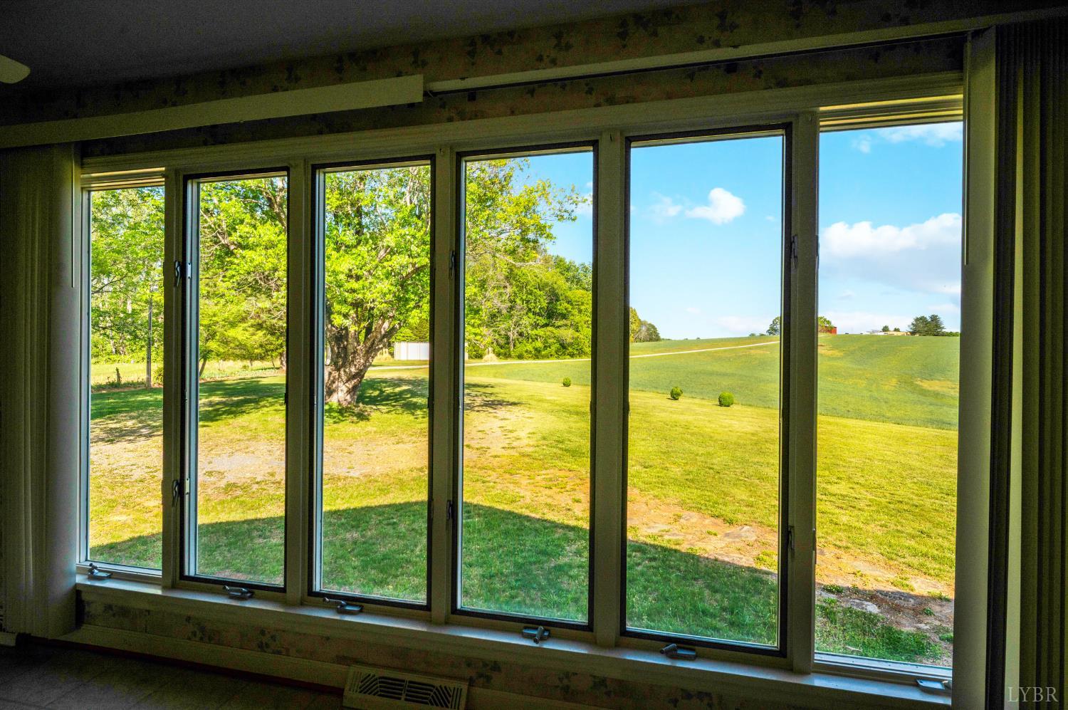 1250 Lick Run Farm Road Forest, VA 24551 - Photo 9 of 74 a view of an empty room with large windows and lake view