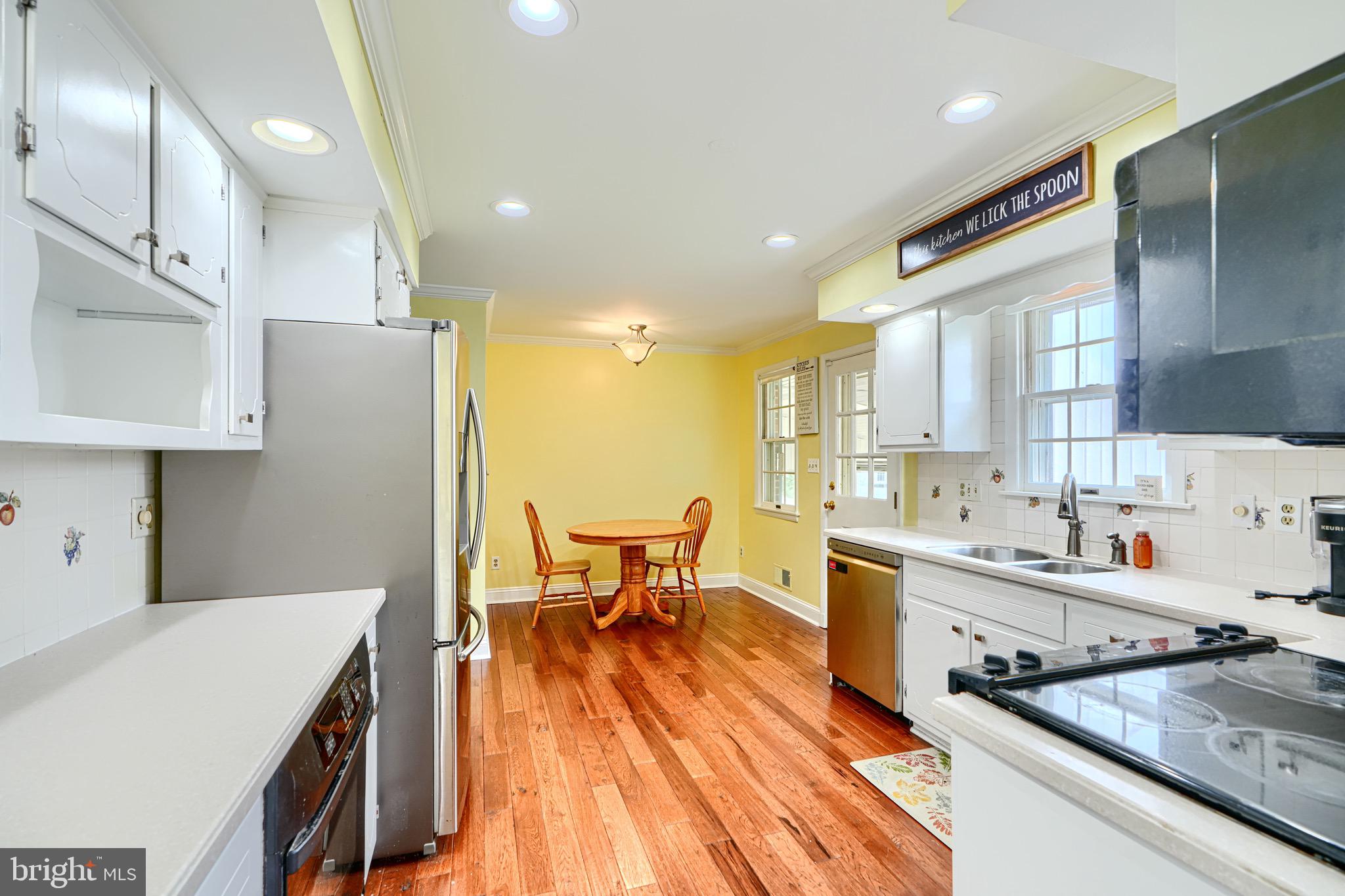 4225 Chapel Road Perry Hall, MD 21128 - Photo 15 of 65 a kitchen with stainless steel appliances granite countertop a refrigerator a sink dishwasher a stove and white countertops with wooden floor