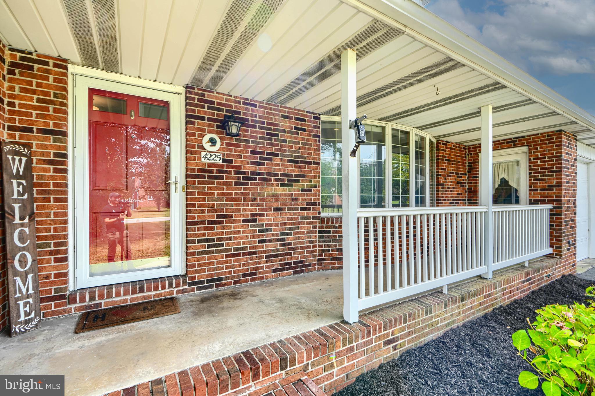 4225 Chapel Road Perry Hall, MD 21128 - Photo 4 of 65 a view of a porch with a table and chair