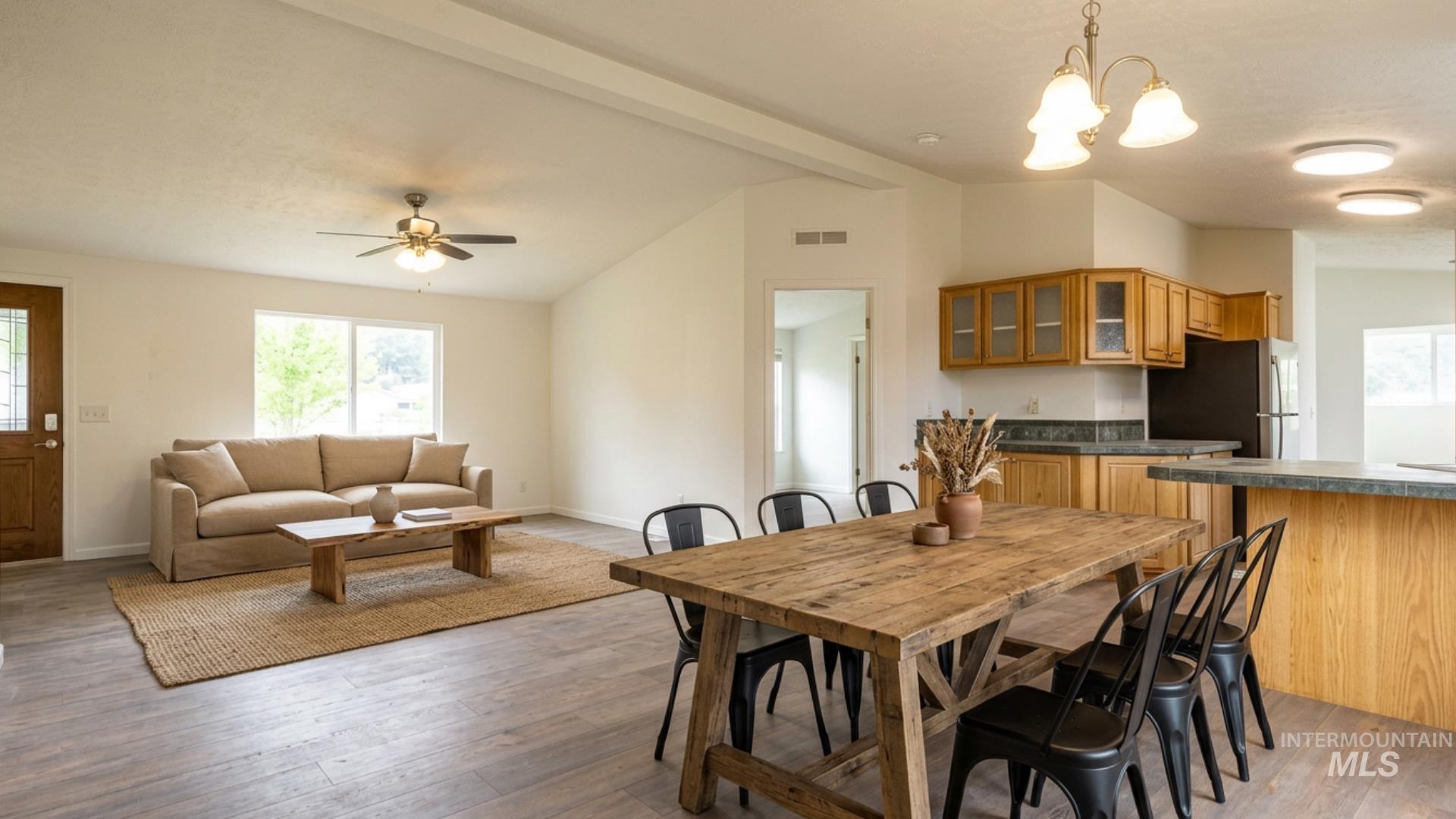 17028 Lower Pleasant Ridge Road Caldwell, ID 83607 - Photo 7 of 21 Open-concept living space featuring wood-finish flooring and vaulted ceilings