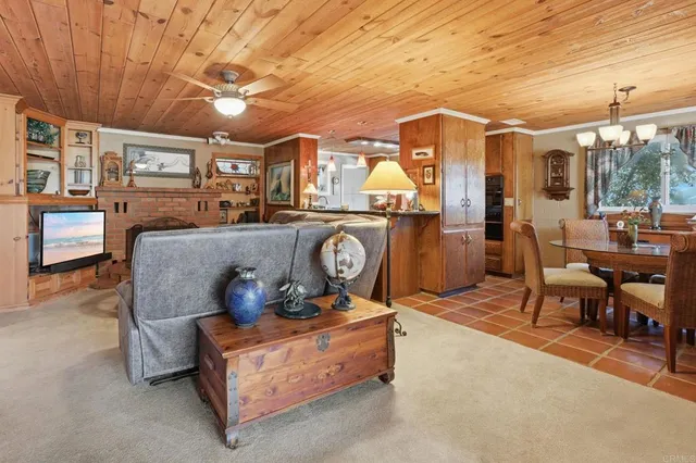 a living room with furniture a flat screen tv and next to a window