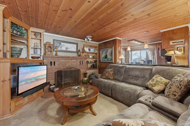 a living room with furniture a large window and a fireplace