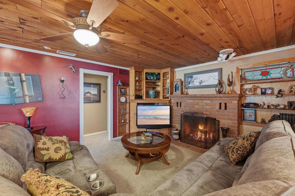 145 Barhaven Lane Fallbrook, CA 92028 - Photo 14 of 46 a living room with furniture and a fireplace