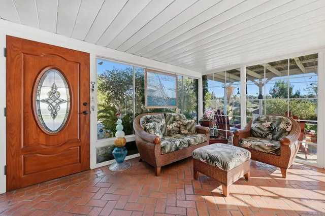 a living room with furniture a rug and a large window