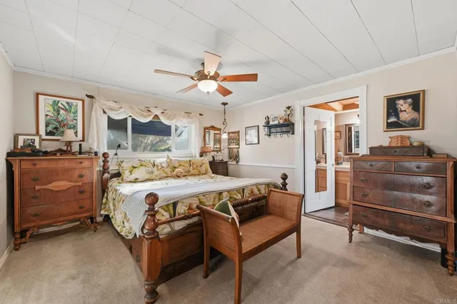 a bedroom with a large bed and a flat tv screen