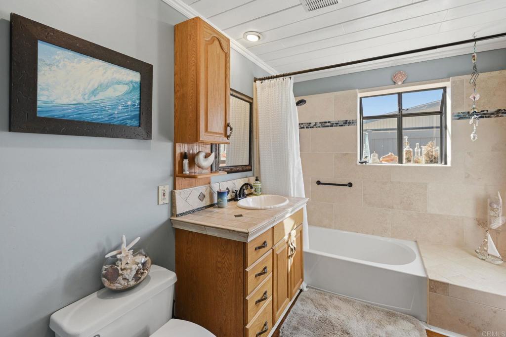 145 Barhaven Lane Fallbrook, CA 92028 - Photo 27 of 46 a bathroom with a tub sink and mirror
