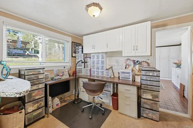 a bedroom with furniture and a large window