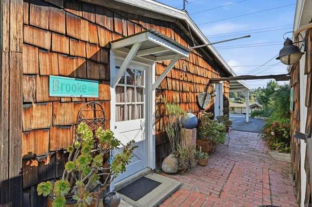 a view of a patio with a table chairs and a yard
