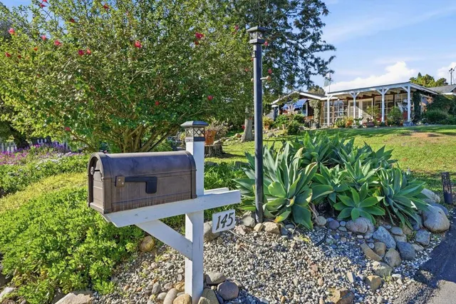 a view of a garden with a house