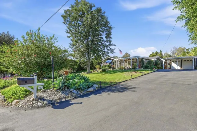 a view of a house with a yard porch and sitting area
