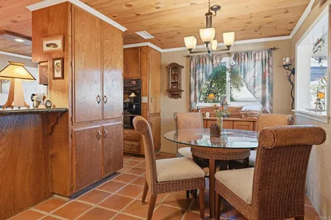 a dining room with furniture a chandelier and window