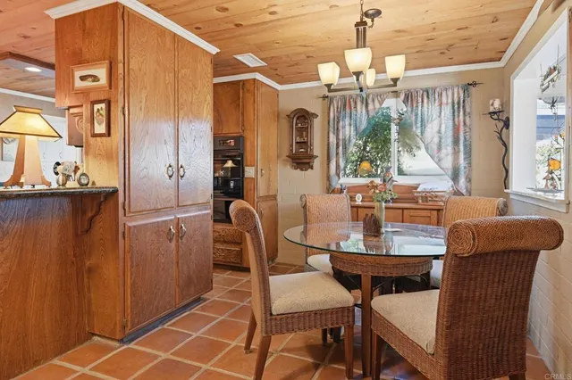 a dining room with furniture a chandelier and window