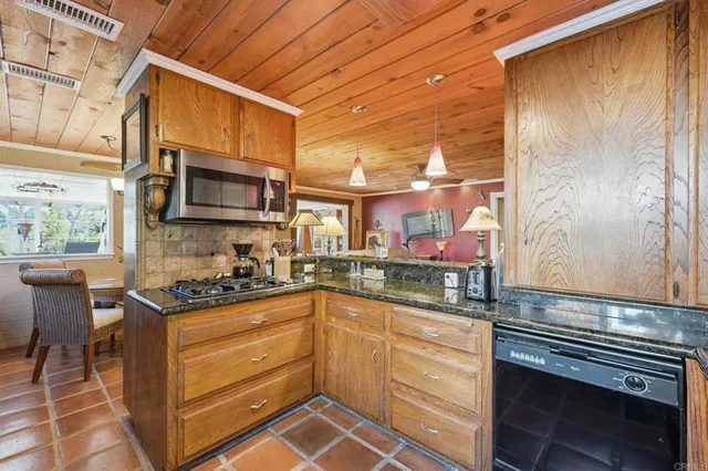 a kitchen with stainless steel appliances granite countertop a sink and cabinets