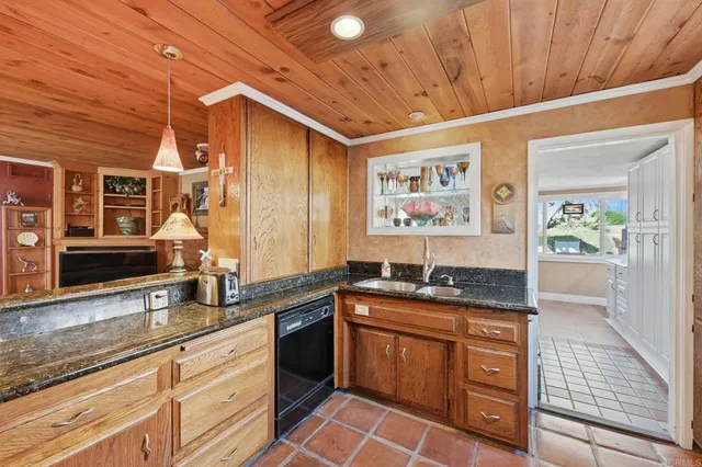 a kitchen with granite countertop a sink and cabinets