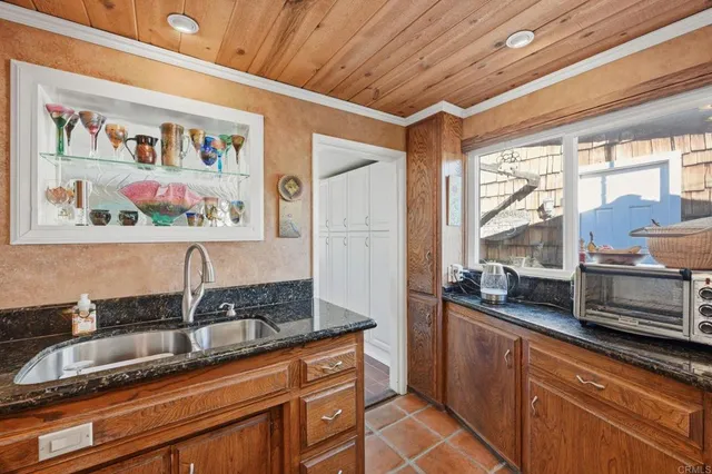 a kitchen with stainless steel appliances granite countertop a sink and a counter space