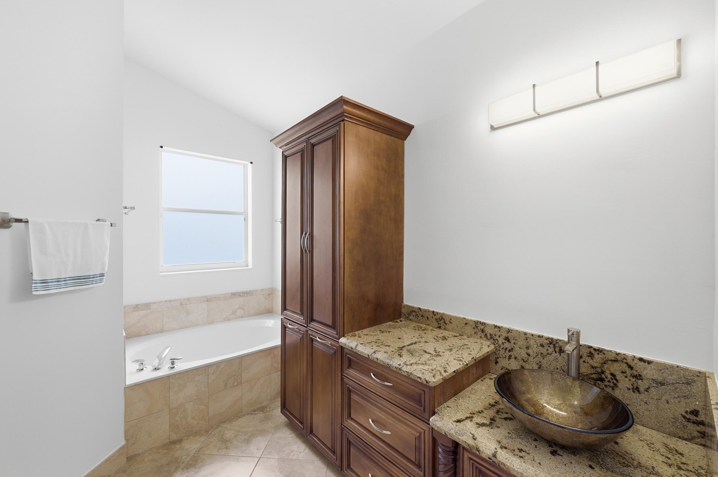 8534 Vía D Oro Boca Raton, FL 33433 - Photo 25 of 34 a bathroom with a tub and shower