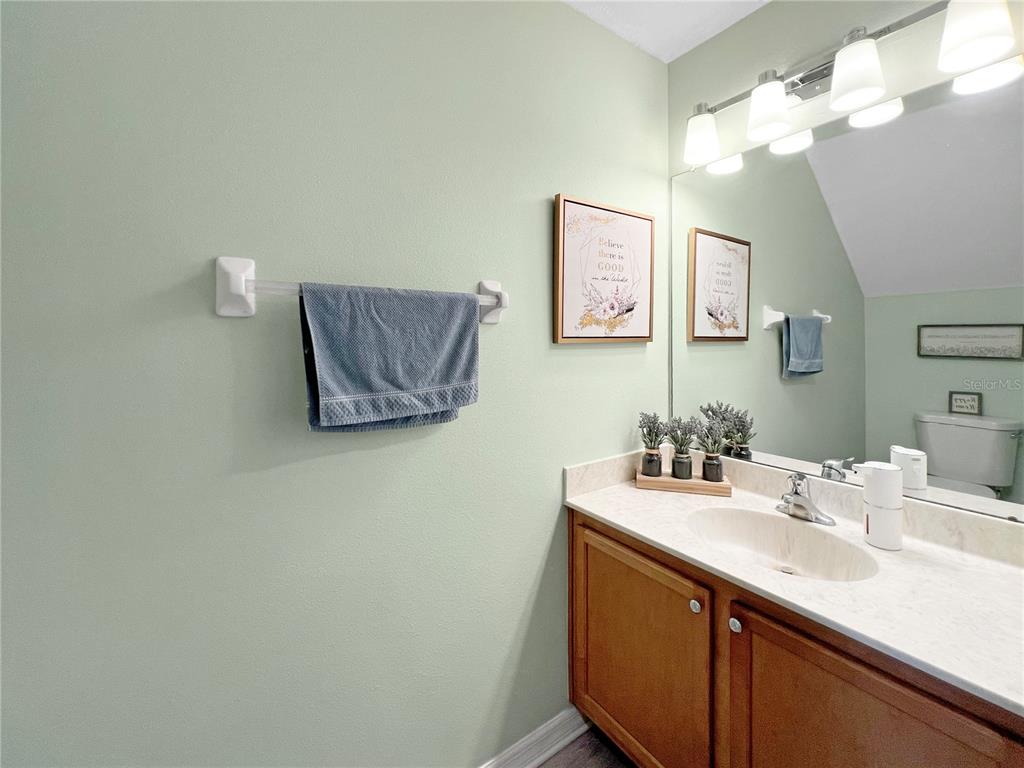 15767 Stable Run Drive Spring Hill, FL 34610 - Photo 19 of 34 a bathroom with a sink vanity and a mirror
