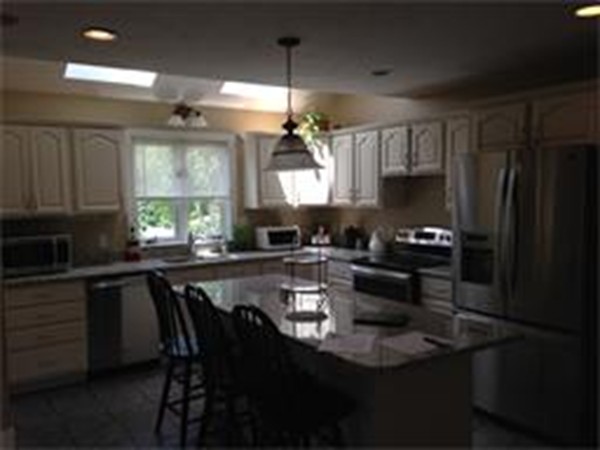 450 Scott Road Oakham, MA 01068 - Photo 3 of 15 a kitchen with a table chairs stove and cabinets