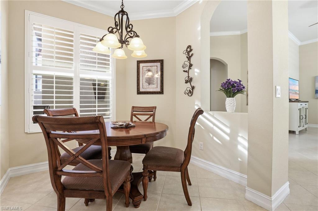 1769 Sanctuary Pointe Court Naples, FL 34110 - Photo 12 of 40 a dining room with furniture and window
