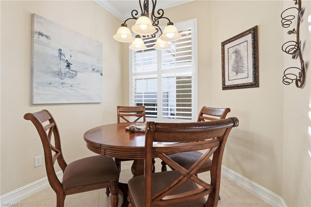 1769 Sanctuary Pointe Court Naples, FL 34110 - Photo 13 of 40 a view of a dining room with furniture and window