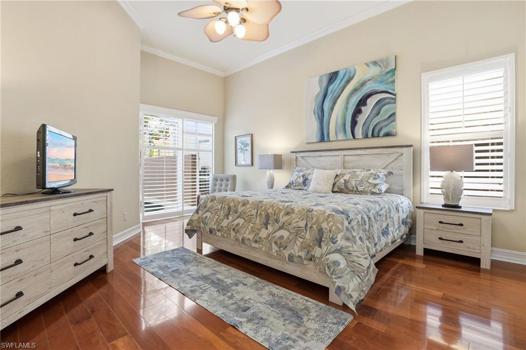 1769 Sanctuary Pointe Court Naples, FL 34110 - Photo 15 of 40 a bedroom with a bed and a flat tv screen on dresser