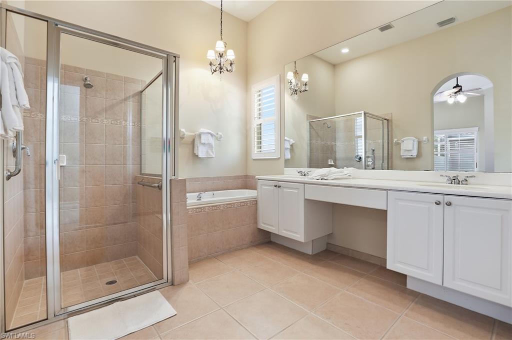 1769 Sanctuary Pointe Court Naples, FL 34110 - Photo 18 of 40 a bathroom with a double vanity sink mirror and shower
