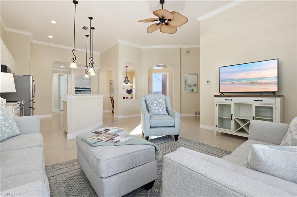 1769 Sanctuary Pointe Court Naples, FL 34110 - Photo 7 of 40 a living room with furniture and a chandelier