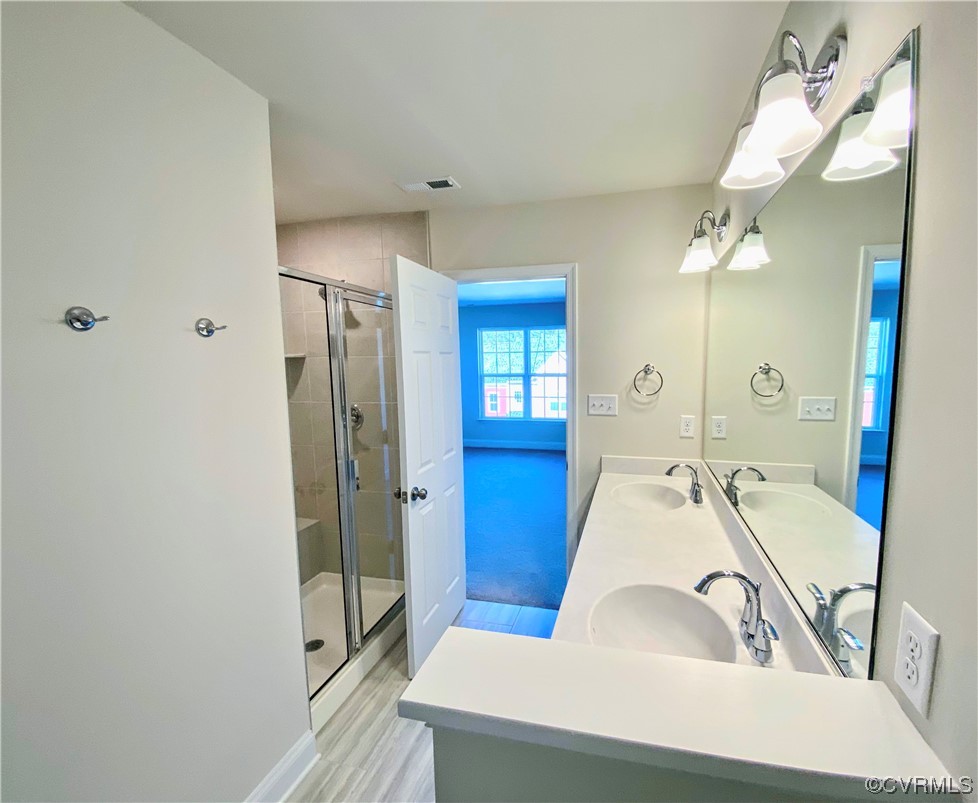 7001 Dunton Road Chesterfield, VA 23832 - Photo 19 of 28 a en suite bathroom with a sink a tub and a mirror