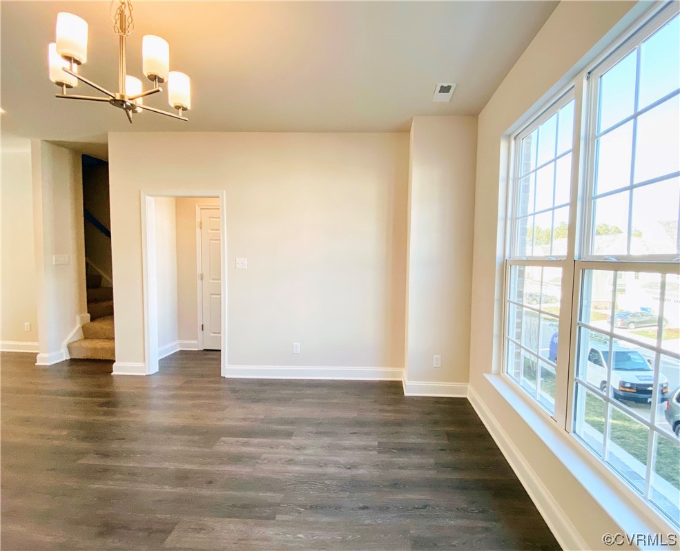 7001 Dunton Road Chesterfield, VA 23832 - Photo 7 of 28 a view of an empty room with wooden floor and a window