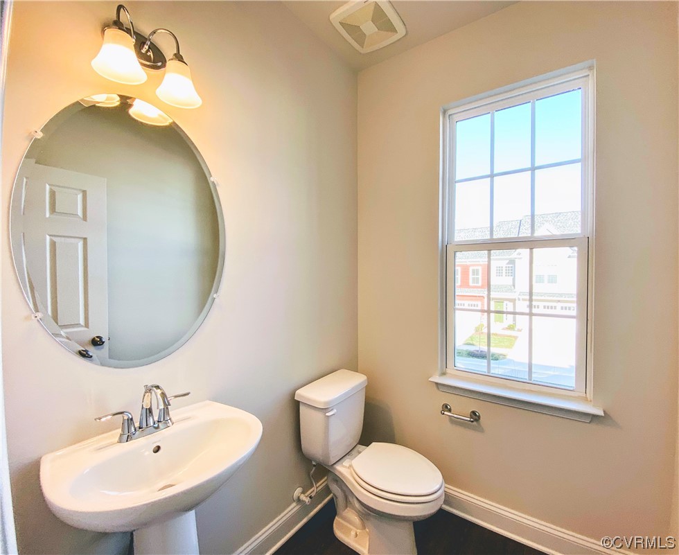 7001 Dunton Road Chesterfield, VA 23832 - Photo 9 of 28 a bathroom with a toilet a sink and mirror
