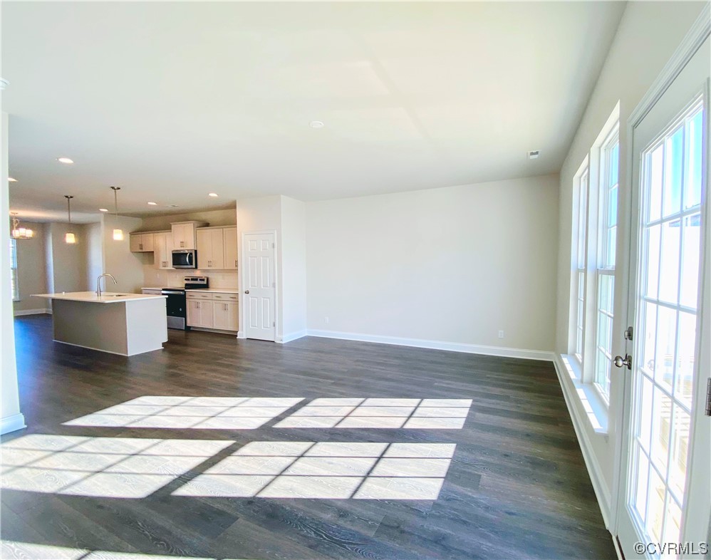 7001 Dunton Road Chesterfield, VA 23832 - Photo 10 of 28 a view of a living room with a kitchen island hardwood floor and a large window