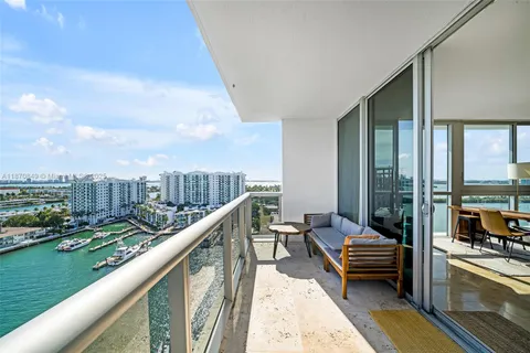 a balcony with outdoor seating and city view