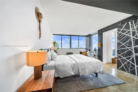 a bedroom with a bed a couch and dresser