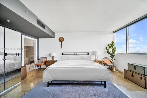 a bedroom with bed and window