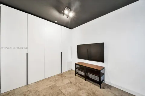 a room with furniture and flat screen tv