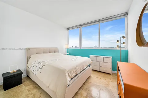 a bedroom with a bed and a television