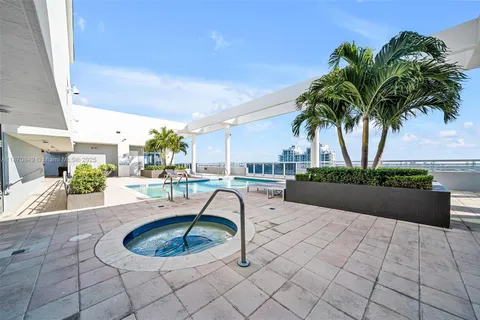 a swimming pool with outdoor seating and a patio
