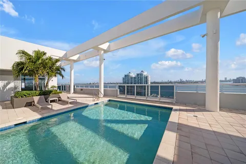a view of a swimming pool with chairs in patio