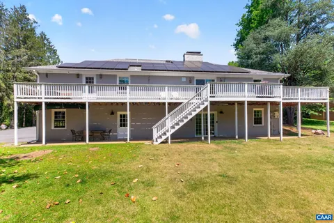 a view of a house with a yard and sitting area