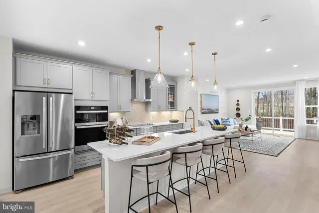 a kitchen with kitchen island granite countertop a table and chairs in it