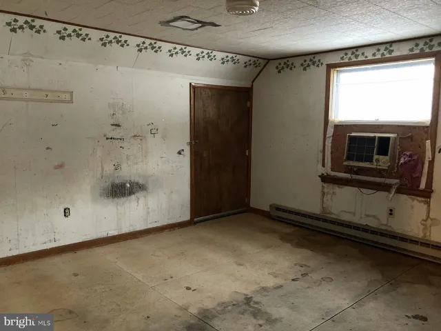 a view of an empty room with a fireplace