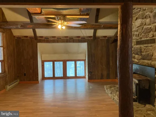 a view of a room with wooden floor